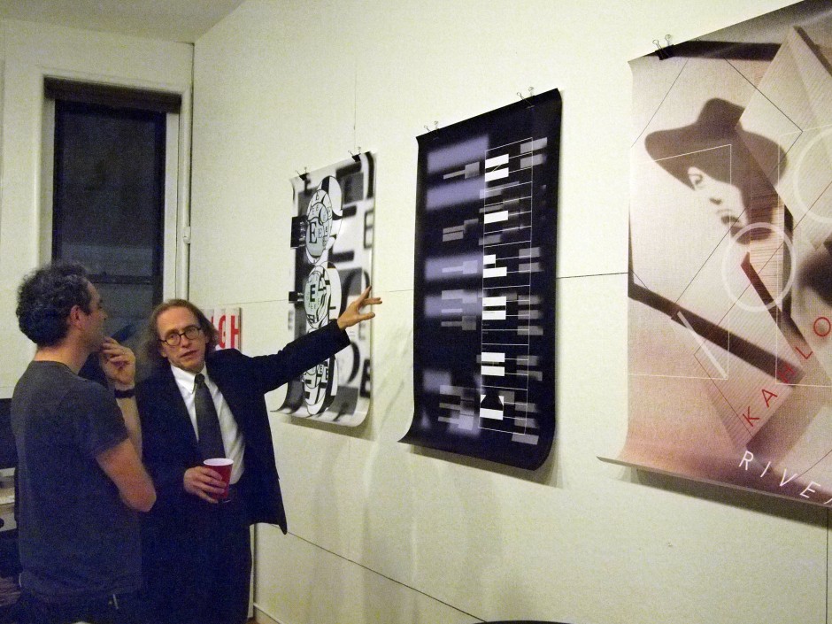 Tom Wedell with three posters that were on view for the event